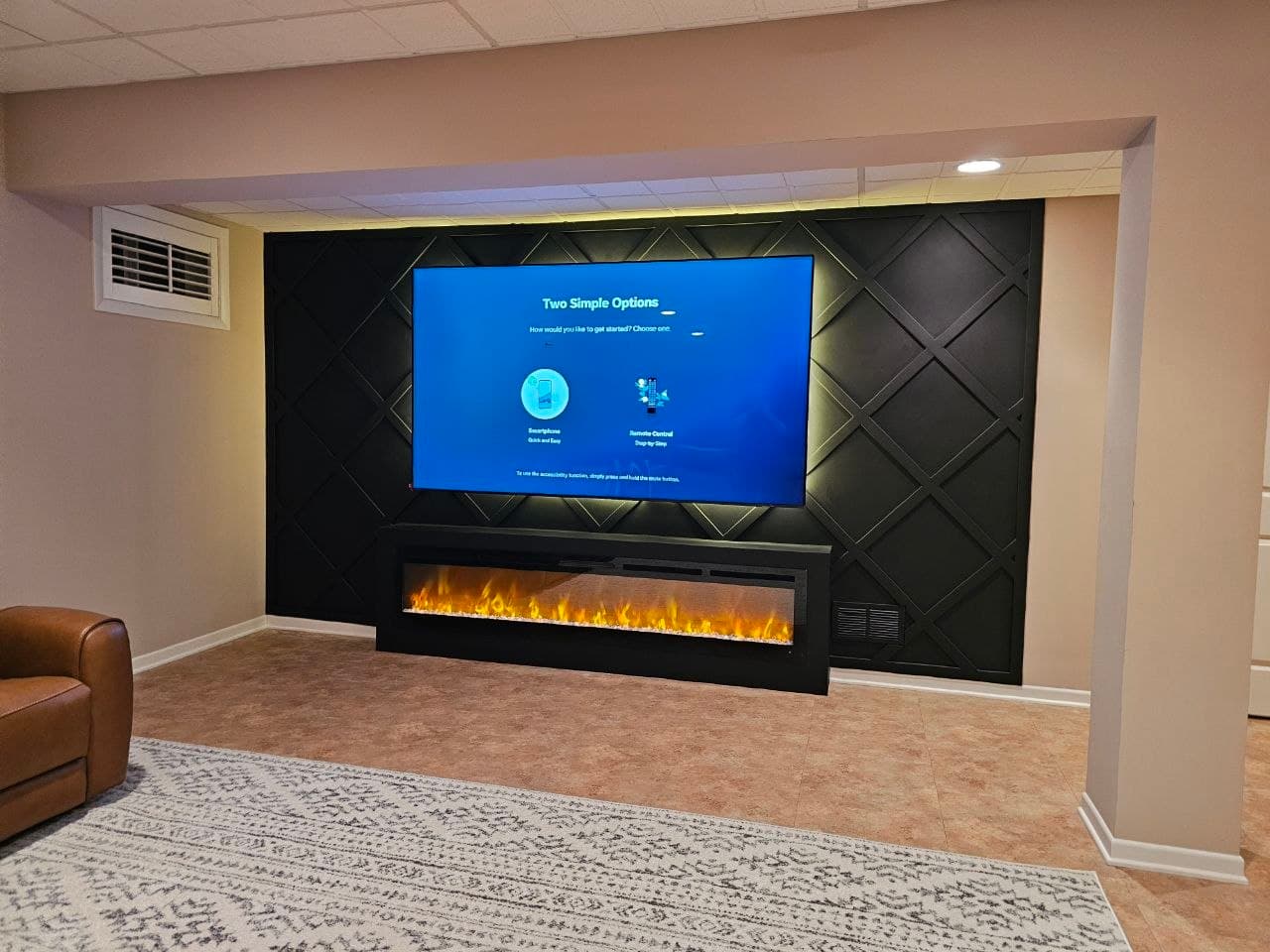 Black diamond lattice media wall with fireplace TV stand in a finished basement